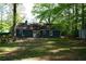View of the home's backyard featuring patio, grill, and lawn at 4120 Highway 92, Acworth, GA 30102