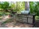 Backyard with outdoor kitchen and cooking area, with green surroundings at 4120 Highway 92, Acworth, GA 30102
