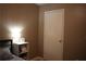 This cozy bedroom features neutral-toned walls and a side table with a lamp at 4120 Highway 92, Acworth, GA 30102