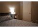 Comfortable bedroom features a neatly made bed, side table with lamp, and closet at 4120 Highway 92, Acworth, GA 30102