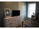 Bedroom with a white dresser beneath a television and a sunlit window with blinds at 4120 Highway 92, Acworth, GA 30102
