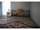 Bedroom highlighting a patterned bed beneath a window and a small shelving unit with décor at 4120 Highway 92, Acworth, GA 30102