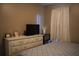 Bedroom highlighting a white dresser, a small television, bed, and window with curtains at 4120 Highway 92, Acworth, GA 30102