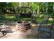 Brick fire pit and swing set on brick patio surrounded by ornate metal chairs, perfect for entertaining at 4120 Highway 92, Acworth, GA 30102