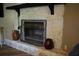 Stone fireplace with mantle and metal screen adds warmth and character to the living space at 4120 Highway 92, Acworth, GA 30102