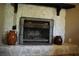 Stone fireplace with mantle and metal screen adds warmth and character to the living space at 4120 Highway 92, Acworth, GA 30102