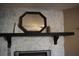 Decorative stone fireplace with a black mantle and octagon shaped mirror at 4120 Highway 92, Acworth, GA 30102