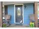 Close-up of front door with decorative glass, flanked by rocking chairs on a cozy porch at 4120 Highway 92, Acworth, GA 30102