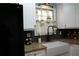 Bright kitchen featuring a stainless fridge, farmhouse sink, and granite countertops at 4120 Highway 92, Acworth, GA 30102