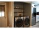 Well-equipped laundry area featuring modern washer and dryer units and practical shelving for organization at 4120 Highway 92, Acworth, GA 30102