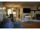 Living room with stone fireplace, hardwood flooring, and a dining area with natural light at 4120 Highway 92, Acworth, GA 30102