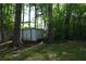 Large storage shed in the wooded backyard area at 4120 Highway 92, Acworth, GA 30102
