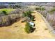 Aerial view of a home surrounded by fields, offering privacy and space in a serene, rural environment at 5333 Pine Valley Rd, Powder Springs, GA 30127