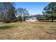 Scenic shot of backyard including the home and surrounding grassy land at 5333 Pine Valley Rd, Powder Springs, GA 30127