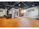 Finished basement with exposed ductwork, open doorway to another room and hardwood accent wall at 5333 Pine Valley Rd, Powder Springs, GA 30127