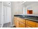 Bathroom features a wooden vanity, solid countertops, a large mirror, and a shower-tub combo at 5333 Pine Valley Rd, Powder Springs, GA 30127