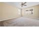 Spacious bedroom features a ceiling fan, plush carpet, and abundant natural light from large windows at 5333 Pine Valley Rd, Powder Springs, GA 30127