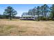 View of the property highlighting the house and its surrounding grassy yard at 5333 Pine Valley Rd, Powder Springs, GA 30127