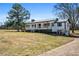 Charming two-story farmhouse with a metal roof, white siding, and a welcoming front porch at 5333 Pine Valley Rd, Powder Springs, GA 30127