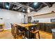 Basement kitchen with island seating, stainless steel appliances, black cabinetry, and light fixtures at 5333 Pine Valley Rd, Powder Springs, GA 30127