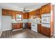 An efficient kitchen with wood cabinets, stainless steel appliances and tile backsplash at 5333 Pine Valley Rd, Powder Springs, GA 30127