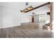 Spacious living room featuring wood-look floors, brick fireplace and ceiling fan at 5333 Pine Valley Rd, Powder Springs, GA 30127