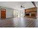 Bright living room with fireplace, ceiling fan, wood floors and windows letting in natural light at 5333 Pine Valley Rd, Powder Springs, GA 30127