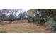 A spacious backyard is surrounded by woods, fencing, and landscaping at 10340 Meadow Crest Ln, Alpharetta, GA 30022