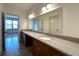 Bathroom boasting double sink vanity with granite countertop and a large frameless mirror at 10340 Meadow Crest Ln, Alpharetta, GA 30022
