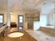 Bathroom featuring dual vanities, granite countertops, tile shower, and soaking tub at 10340 Meadow Crest Ln, Alpharetta, GA 30022
