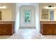 Bathroom with dual vanities, granite countertops, and tile flooring at 10340 Meadow Crest Ln, Alpharetta, GA 30022