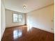 Bedroom with hardwood floors and natural light from a window at 10340 Meadow Crest Ln, Alpharetta, GA 30022