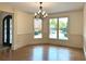Elegant dining room with hardwood floors, chandelier, and large windows at 10340 Meadow Crest Ln, Alpharetta, GA 30022