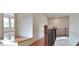 Upstairs hallway showcasing hardwood floors, staircase and a view into another room at 10340 Meadow Crest Ln, Alpharetta, GA 30022