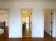 Hallway with hardwood flooring and doorways to other rooms, allowing for easy access and flow at 10340 Meadow Crest Ln, Alpharetta, GA 30022