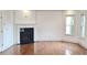 Bright living room with hardwood floors, fireplace, and exterior views at 10340 Meadow Crest Ln, Alpharetta, GA 30022