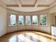 Bright living room featuring hardwood floors, large windows, and tray ceiling at 10340 Meadow Crest Ln, Alpharetta, GA 30022