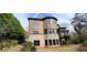 Back exterior view showcasing a two-story home, combination brick and siding, many windows, and deck at 10340 Meadow Crest Ln, Alpharetta, GA 30022