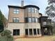 Rear exterior view: two-story brick and siding house with many windows and a pleasant deck at 10340 Meadow Crest Ln, Alpharetta, GA 30022