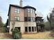 A view of the rear exterior featuring a two-story house, brick, siding, and a charming deck at 10340 Meadow Crest Ln, Alpharetta, GA 30022