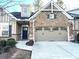 Front view of lovely brick townhome with a 2-car garage at 2330 Callaway Ct, Cumming, GA 30041