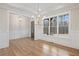 Bright dining room with hardwood floors, wainscoting, and chandelier, overlooking backyard at 325 Mont Harmony Sw Rd, Powder Springs, GA 30127