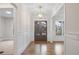 Bright and airy entryway features hardwood floors and a charming wood door at 325 Mont Harmony Sw Rd, Powder Springs, GA 30127