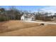 A white house with a 3 car garage and manicured lawn at 325 Mont Harmony Sw Rd, Powder Springs, GA 30127