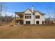 Home's back view featuring a large deck and backyard at 325 Mont Harmony Sw Rd, Powder Springs, GA 30127