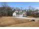 House exterior showcasing a large yard and driveway at 325 Mont Harmony Sw Rd, Powder Springs, GA 30127