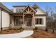 Brick front porch with wooden beams and a double front door at 325 Mont Harmony Sw Rd, Powder Springs, GA 30127