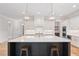 Modern kitchen with white cabinets, a large island, and gold fixtures at 325 Mont Harmony Sw Rd, Powder Springs, GA 30127