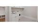 Laundry room with white cabinets, patterned tile floor, and utility sink at 325 Mont Harmony Sw Rd, Powder Springs, GA 30127