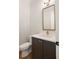 Modern powder room with dark vanity and gold fixtures at 325 Mont Harmony Sw Rd, Powder Springs, GA 30127